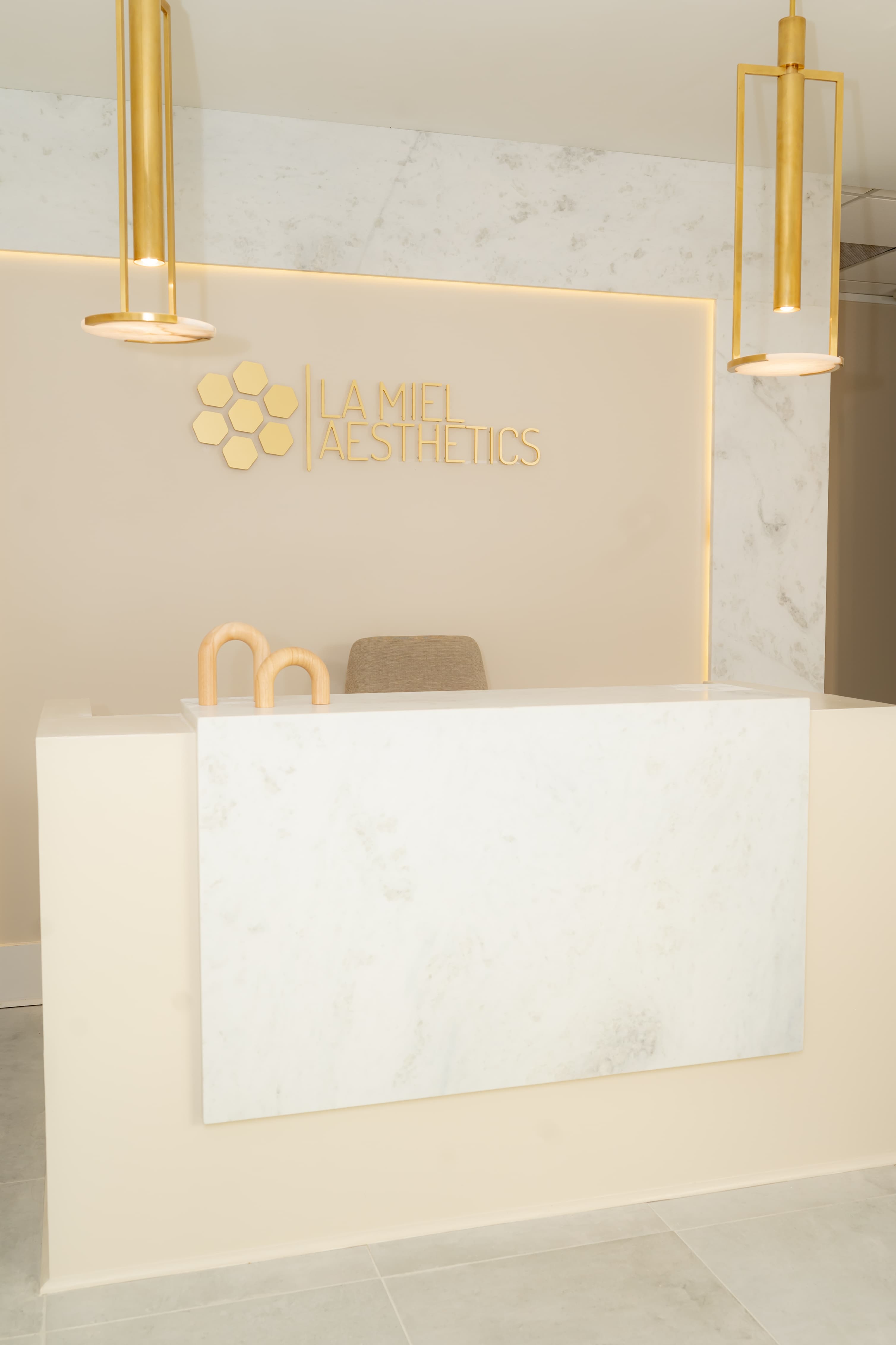 Marble reception desk and entryway at La Miel Aesthetics medical spa in North Raleigh, NC.